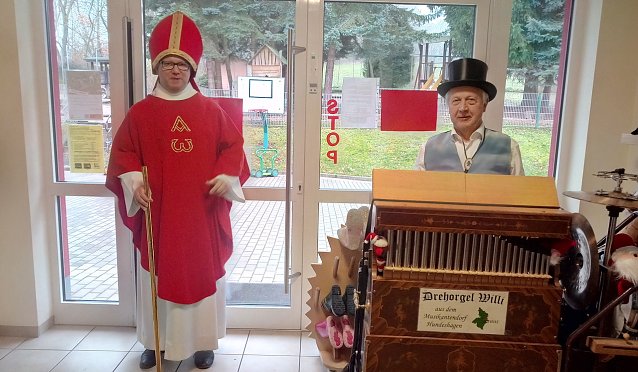 Bild: Pfarrer Tobias Reinhold als Bischof Nikolaus und Wilhelm Reimann an seiner Drehorgel. 